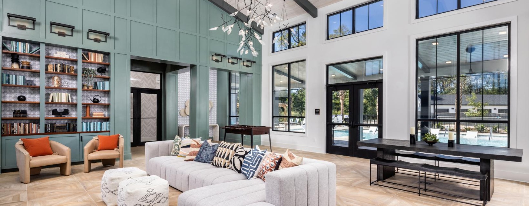 a large room with a large glass wall and a couch and a table