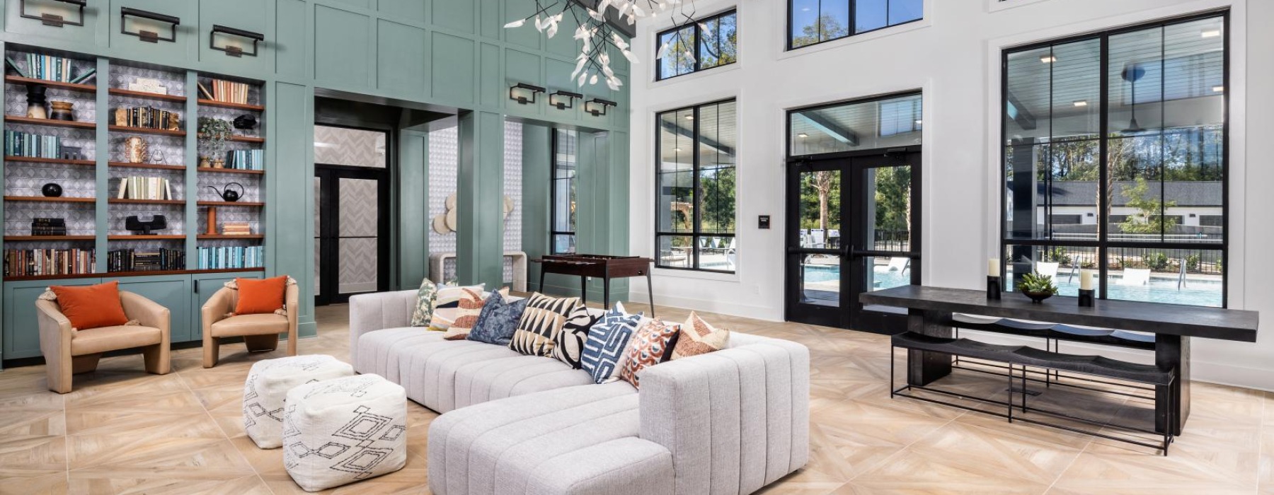 a large room with a large glass wall and a couch and a table