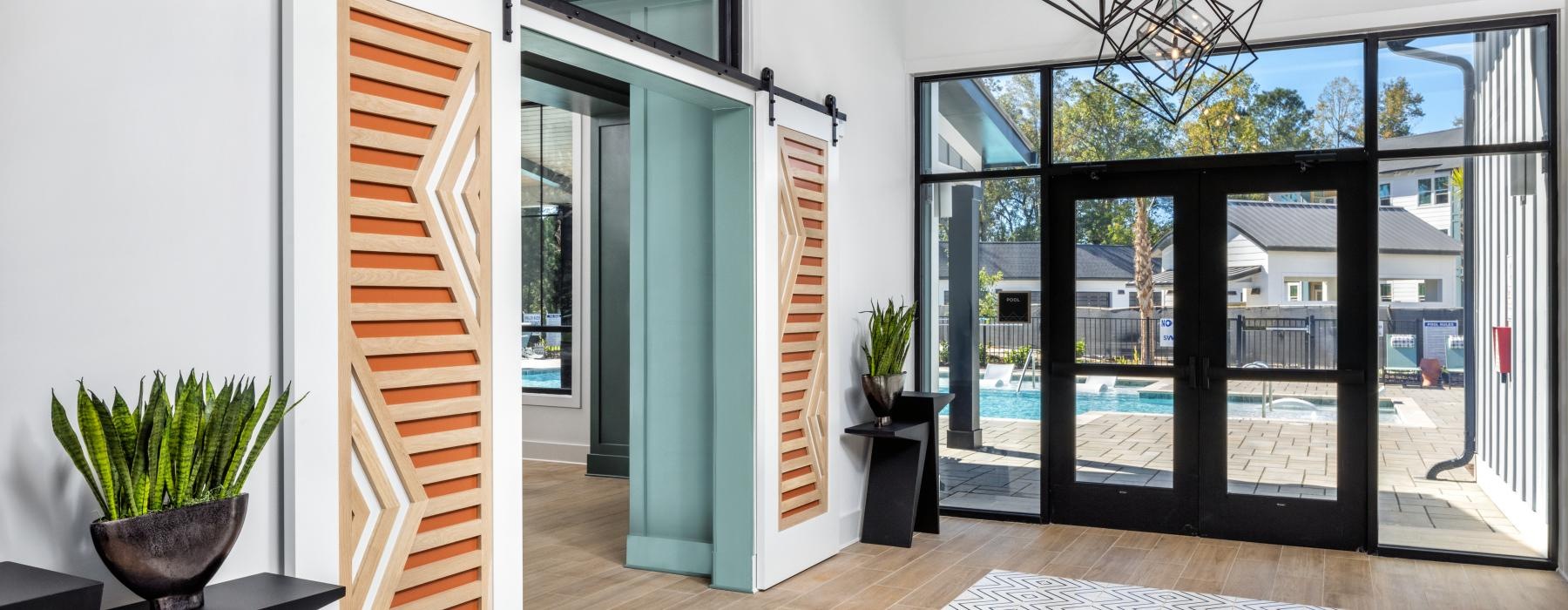 a room with glass doors and a rug