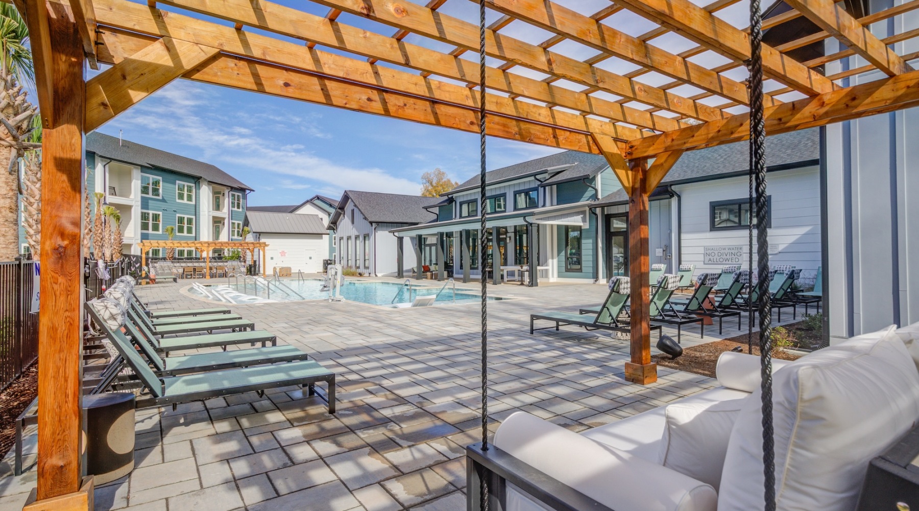 Resort-style swimming pool with lounge seating