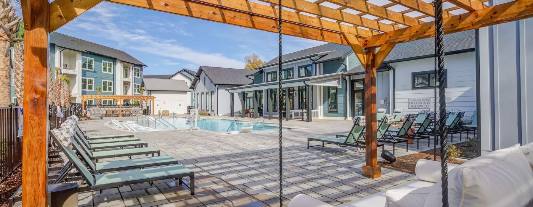 Resort-style swimming pool with lounge seating