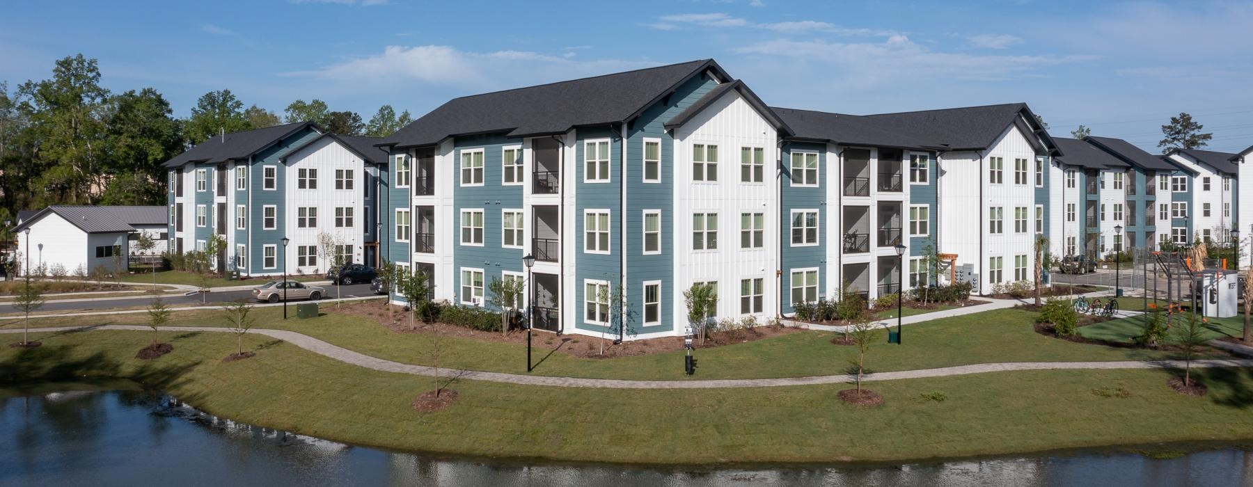 a row of apartment buildings next to a body of water